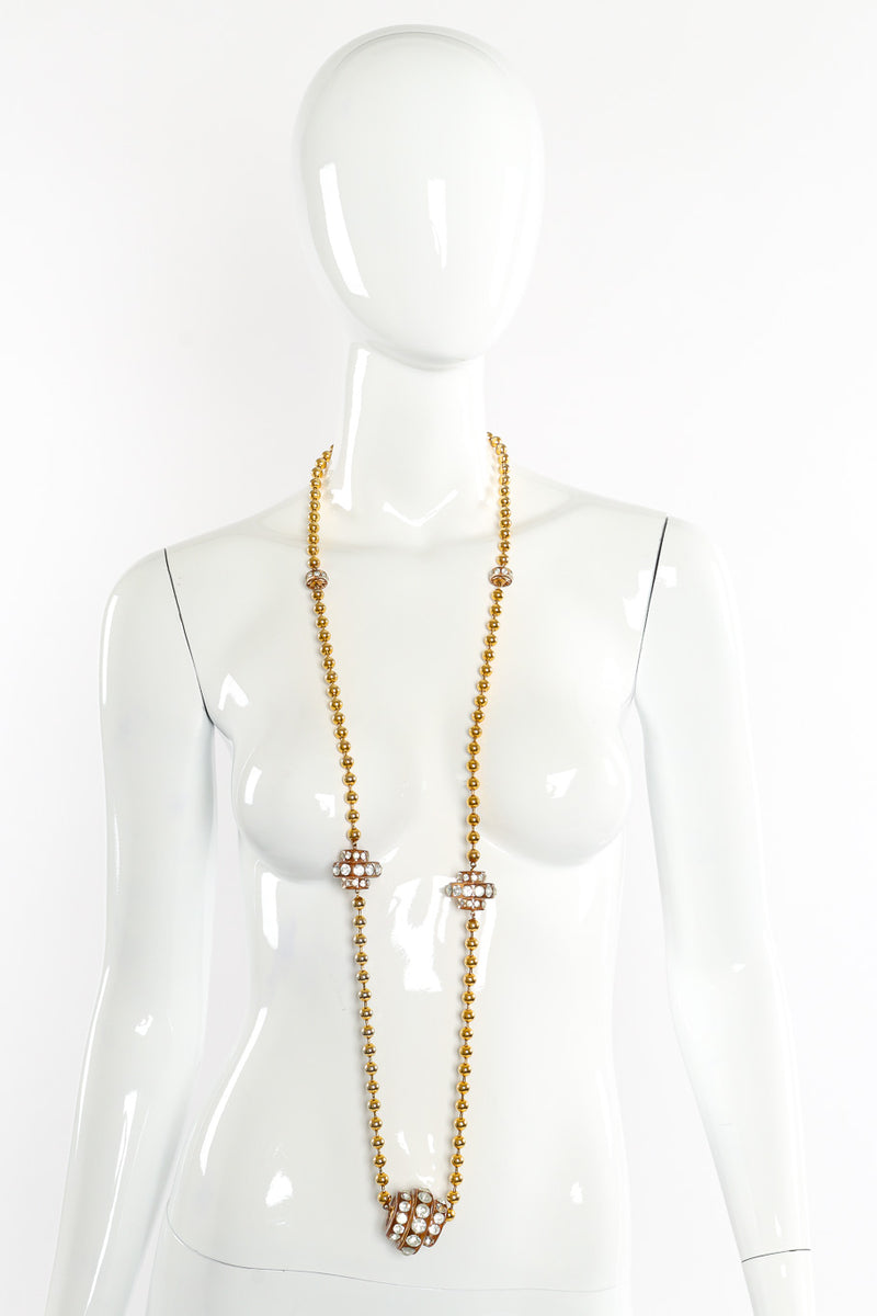 Vintage lucite disc necklace on white background around mannequin neck once @recessla