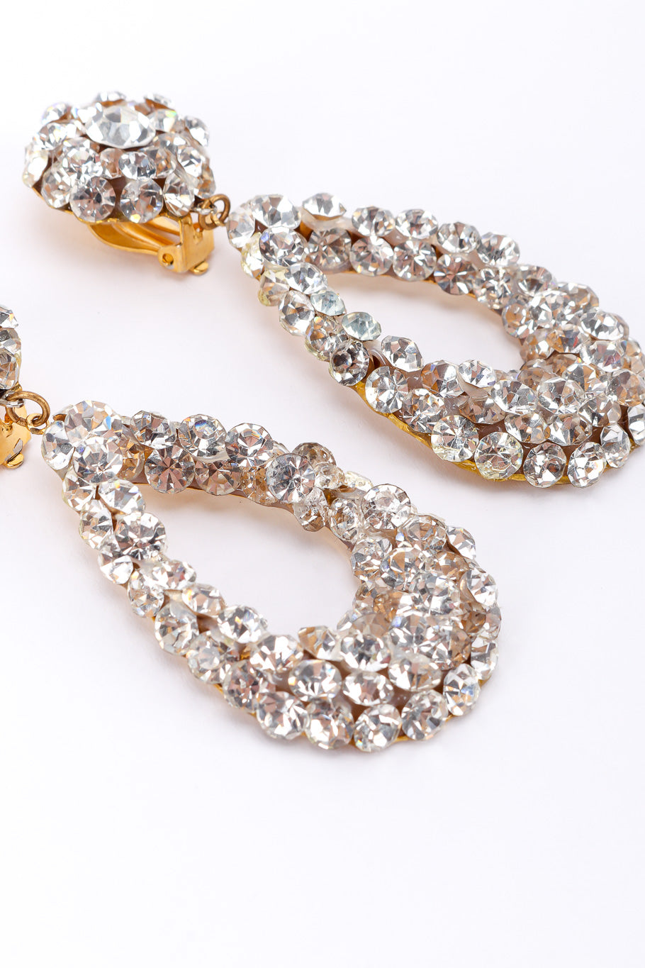 Vintage rhinestone tear-drop earrings on white background bottoms close @recessla