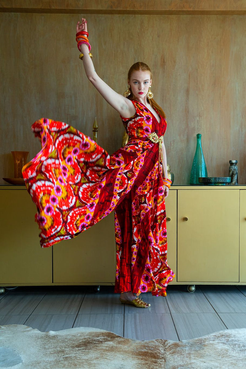 On model in front of wood wall raising one leg and arm