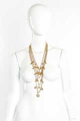 Coin pendant necklace by Goldette on white background on mannequin @recessla