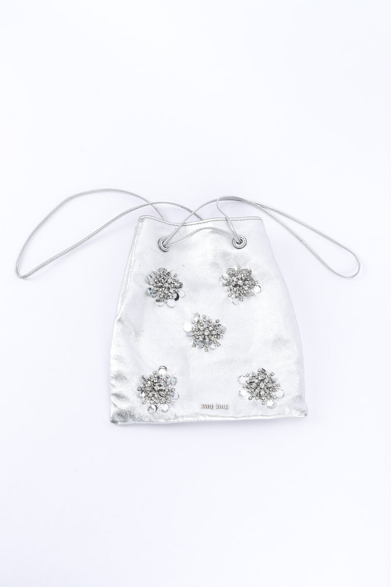 Miu Miu Metallic Drawstring Bag laid flat on white backdrop @Recessla