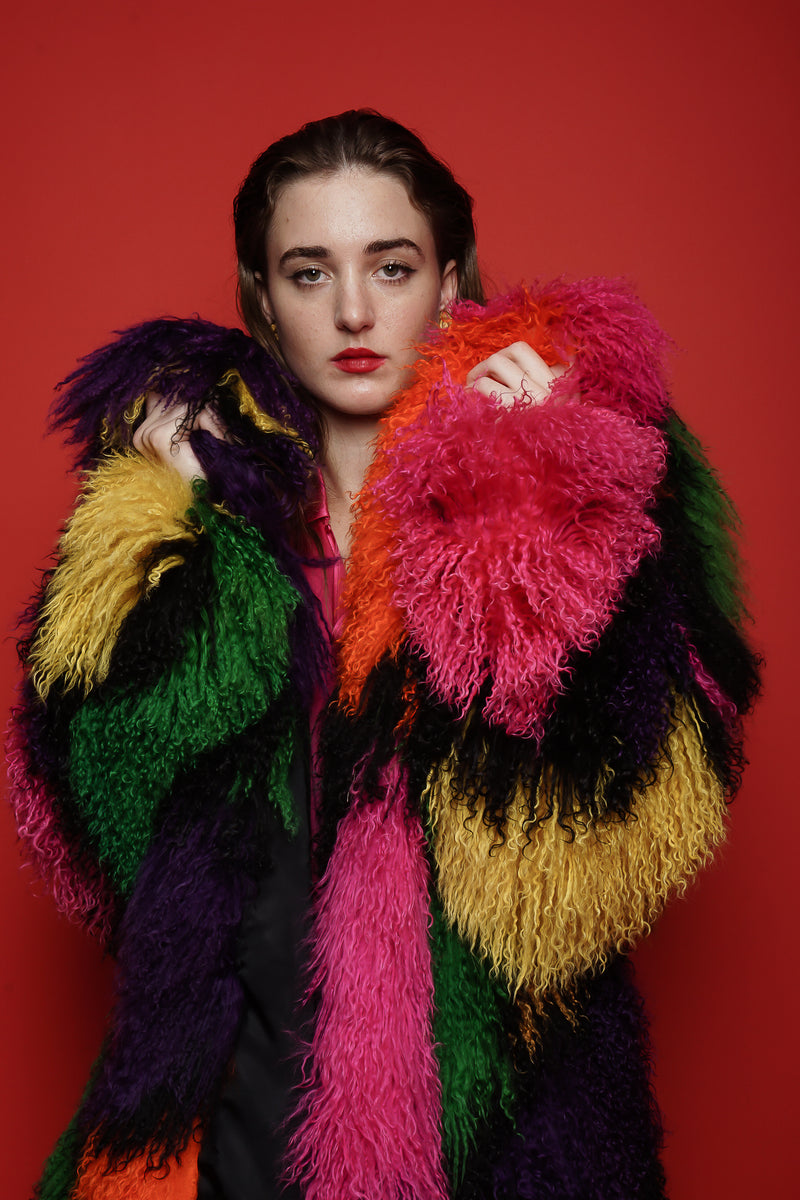 Girl in Vintage Neiman Marcus Rainbow Mosaic Mongolian Fur Coat on red background @ Recess LA