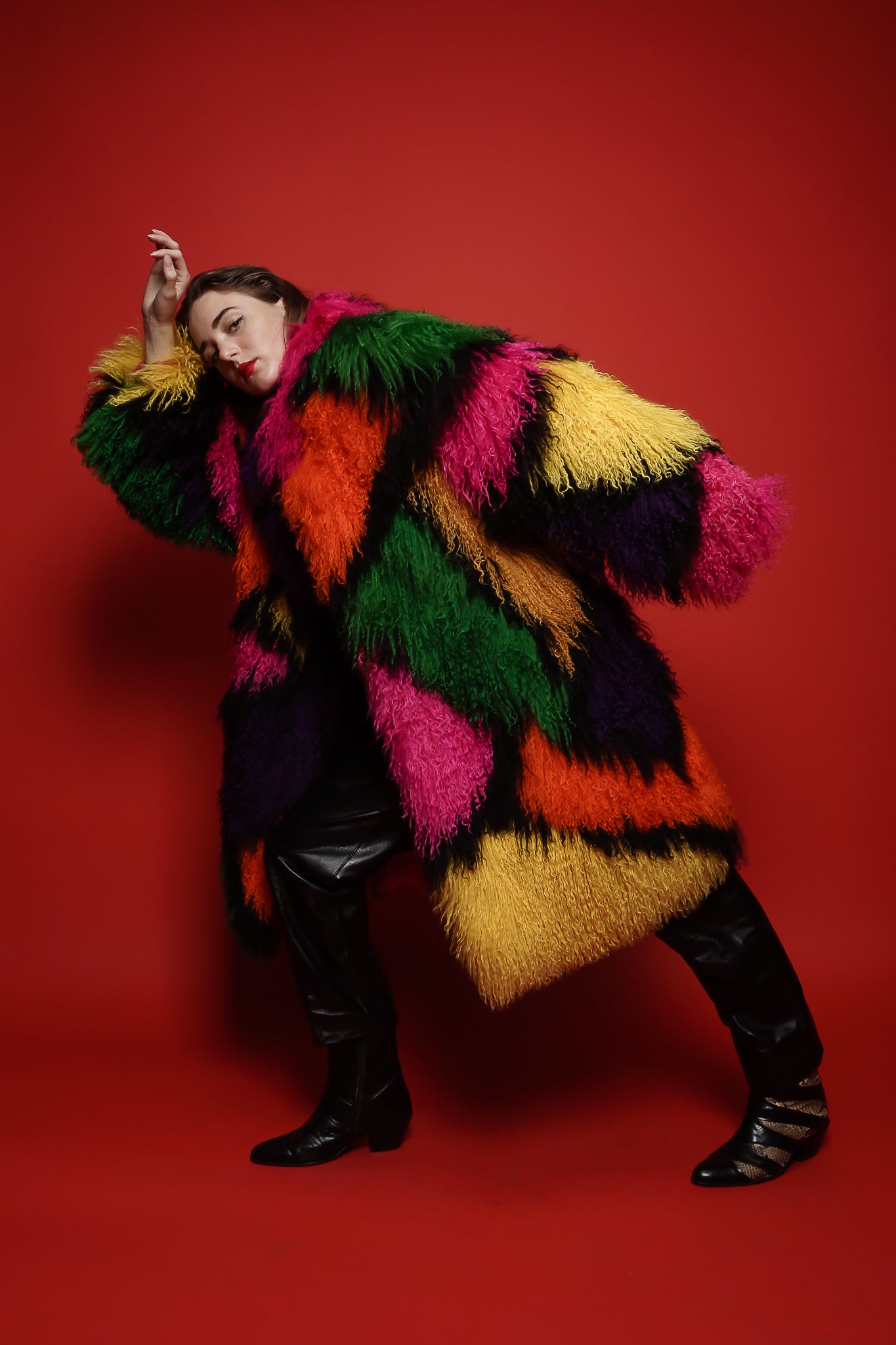 Girl in Vintage Neiman Marcus Rainbow Mosaic Mongolian Fur Coat on red background @ Recess LA