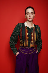 Girl in Vintage Todd Oldham Print Silk Vest, purple pant, & green stripe blouse on red @ Recess LA