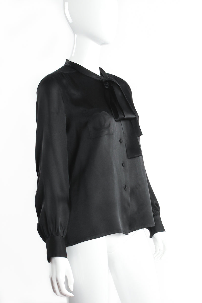 Vintage Chanel CC Pocket Black Silk Tie Neck Blouse on mannequin angle at Recess Los Angeles