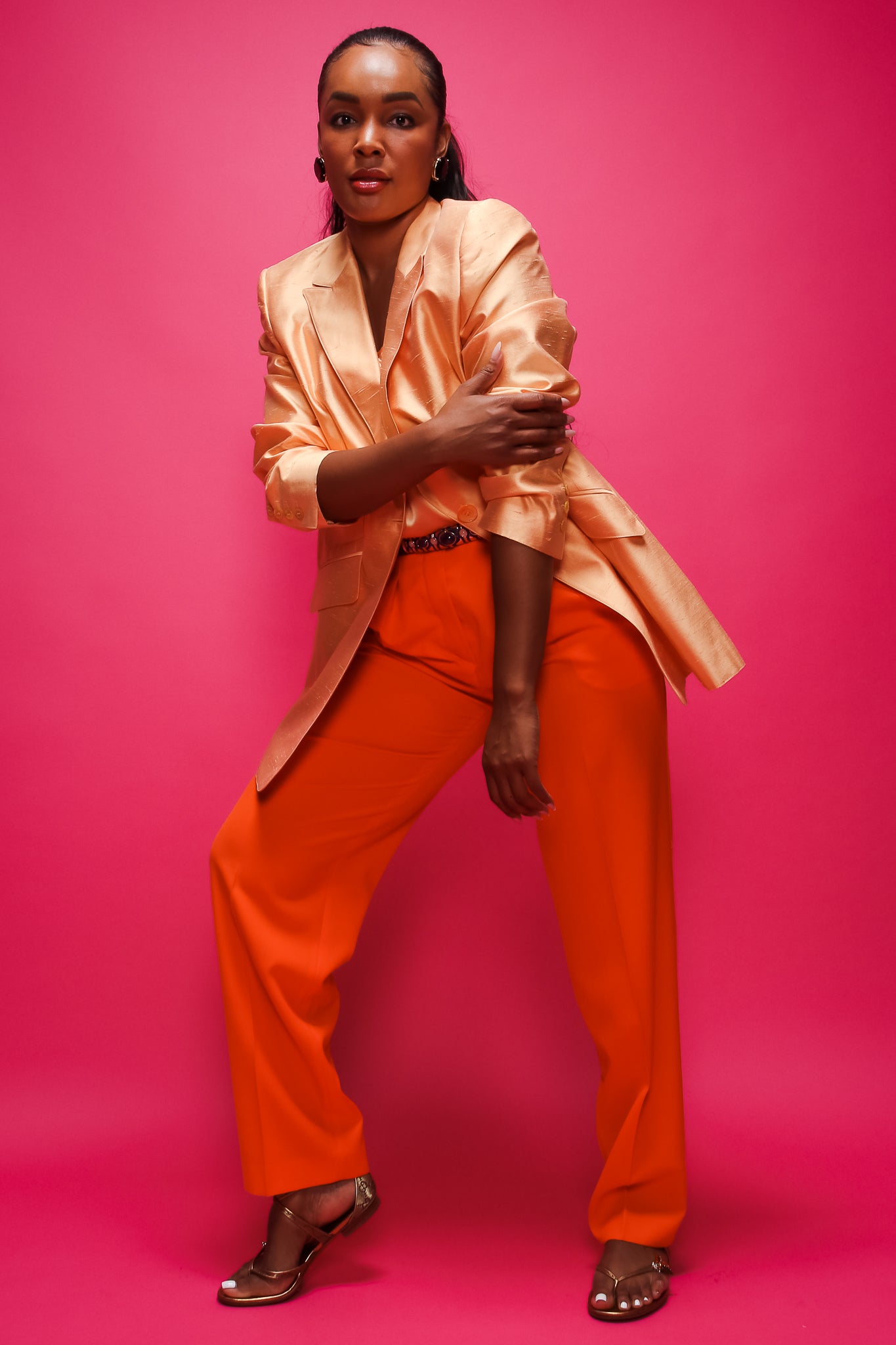 Brittany Hampton in Vintage Escada Orange Double Pleated Pant on pink at Recess Los Angeles