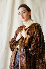 Girl in Vintage Diane Freis Plush Silk Tinsel Cape Coat & YSL leather pant at Recess Los Angeles