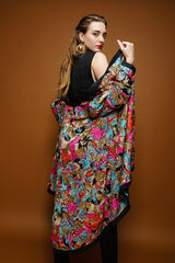 girl in Vintage Diane Freis Tropical Beaded Silk Duster and Alaia knit set on brown @ Recess LA