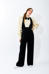 Girl in Vintage Sonia Rykiel Cream Knit Bow Tie Sweater with black suspender pants