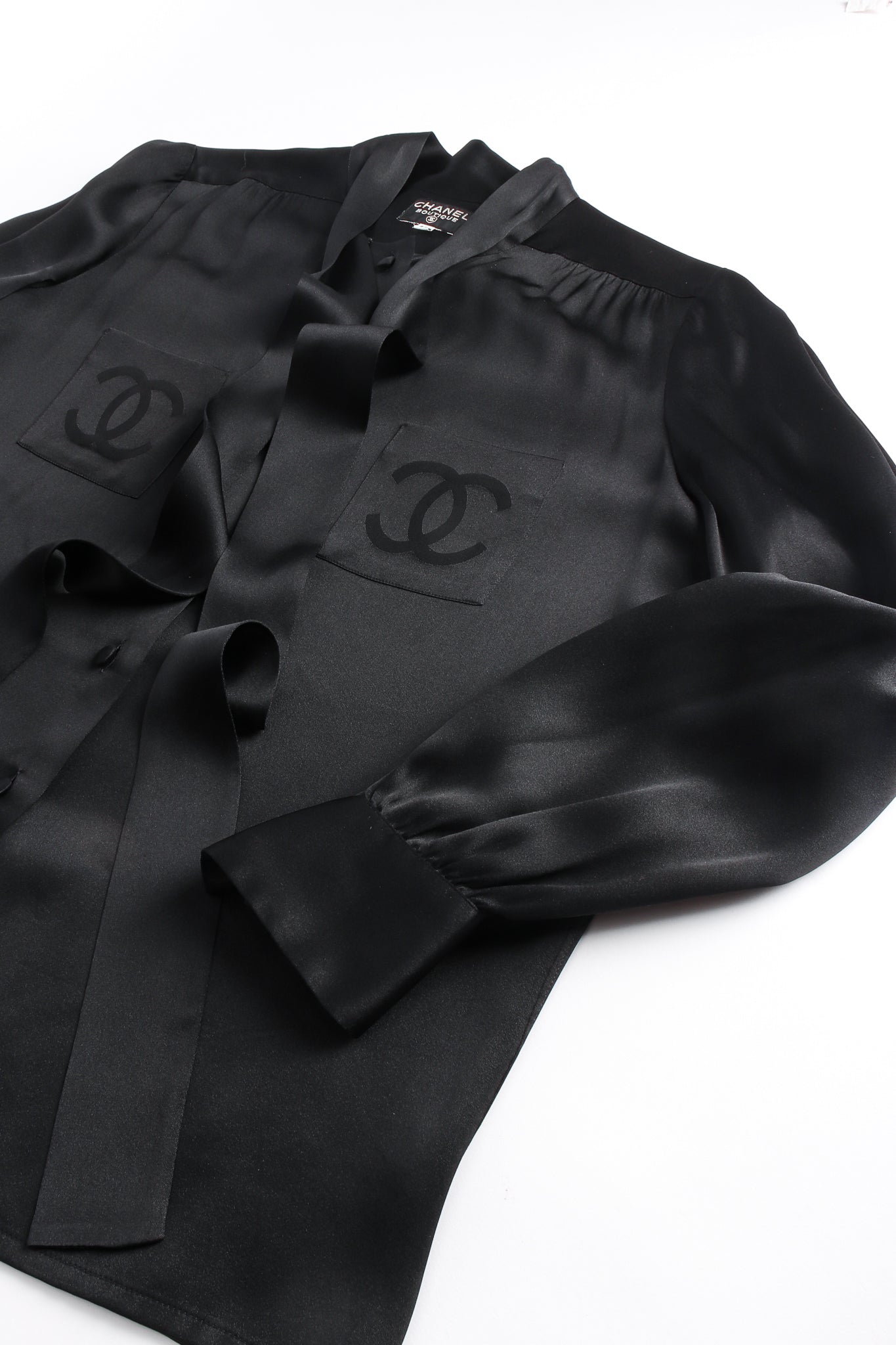 Vintage Chanel CC Pocket Black Silk Tie Neck Blouse flat at Recess Los Angeles